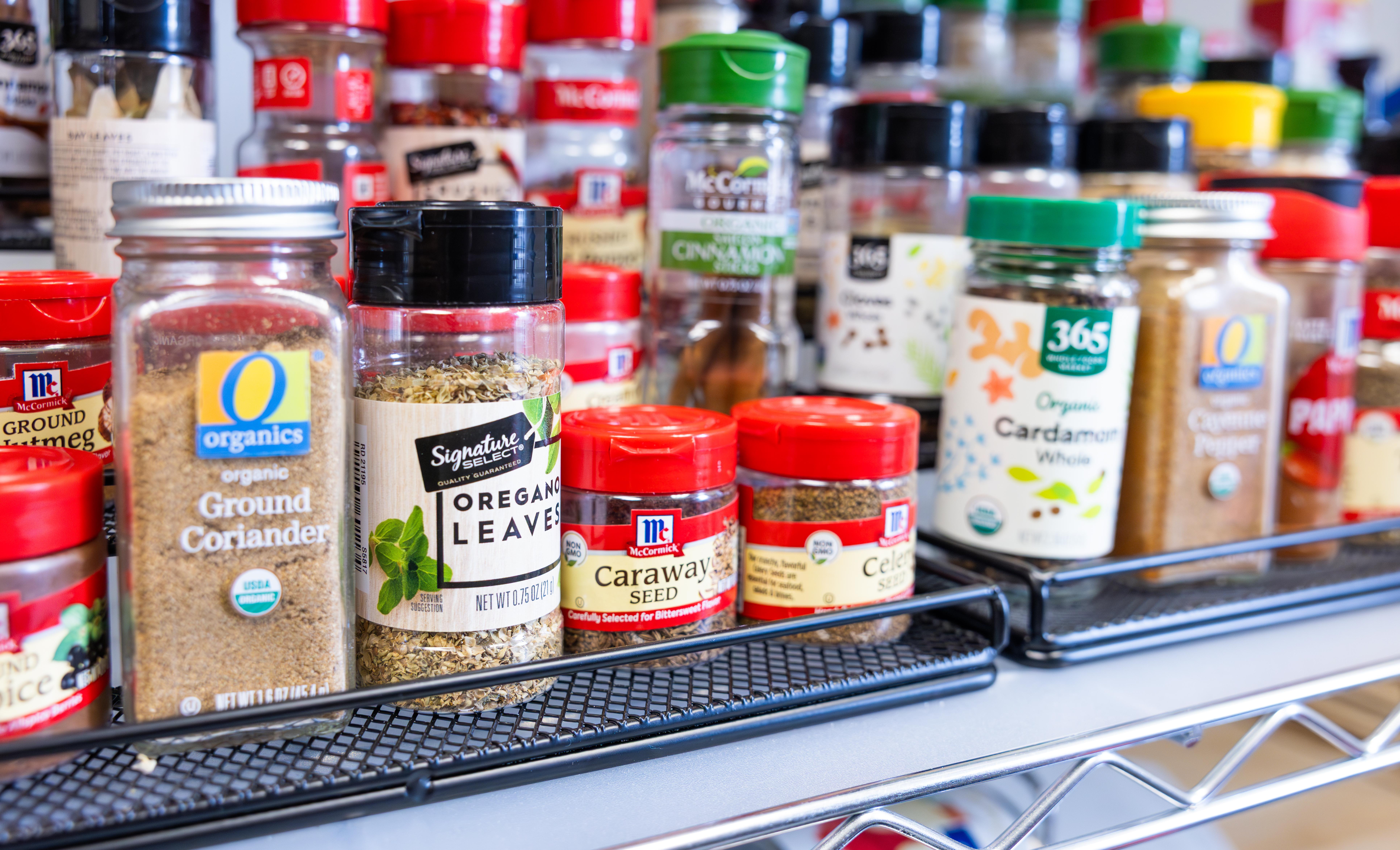 Close up of colorful spice containers, including ground coriander, oregano leaves, caraway seed, and more, in the Nutrition Lab.