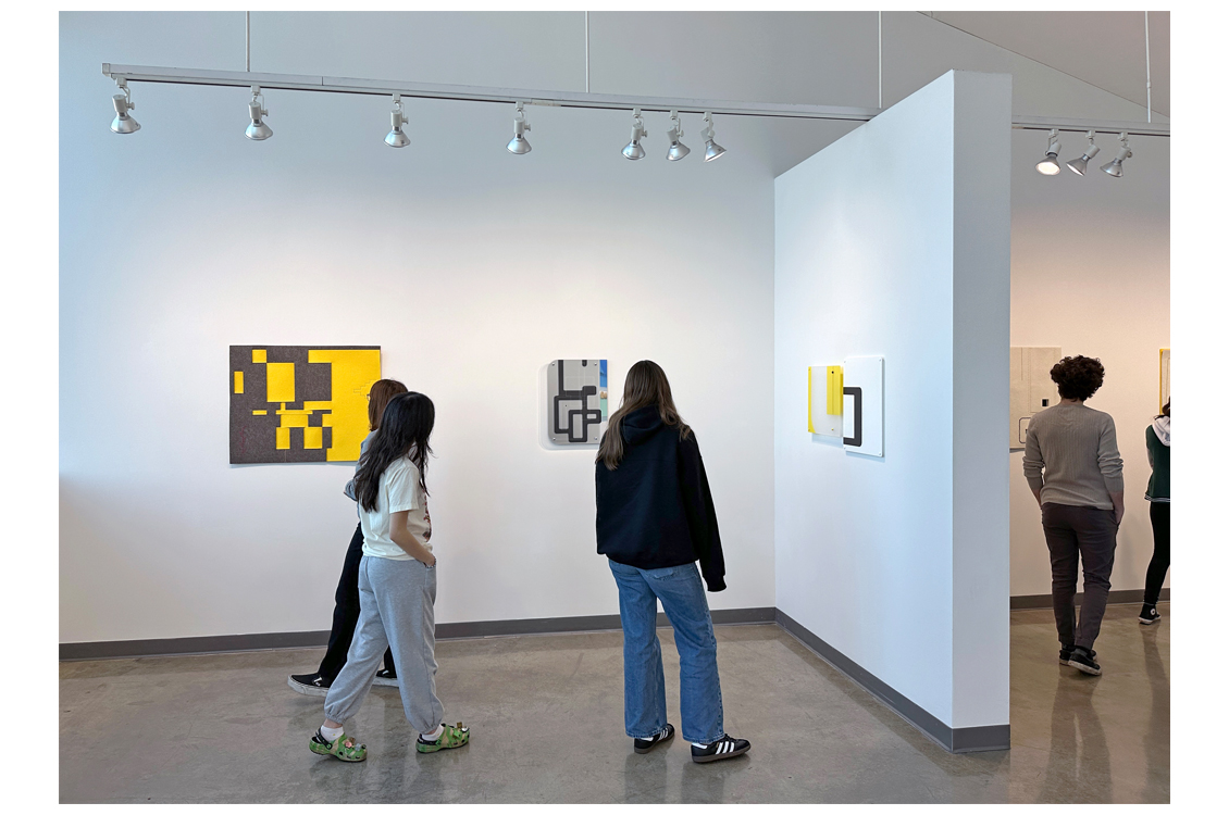 students looking at art on gallery floor