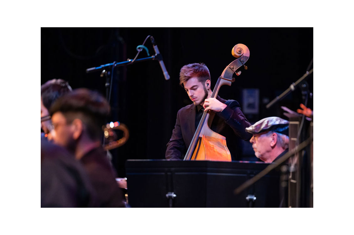 a student plays the cello at a concert