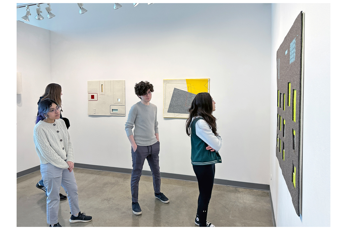 students looking at large work of art in gallery