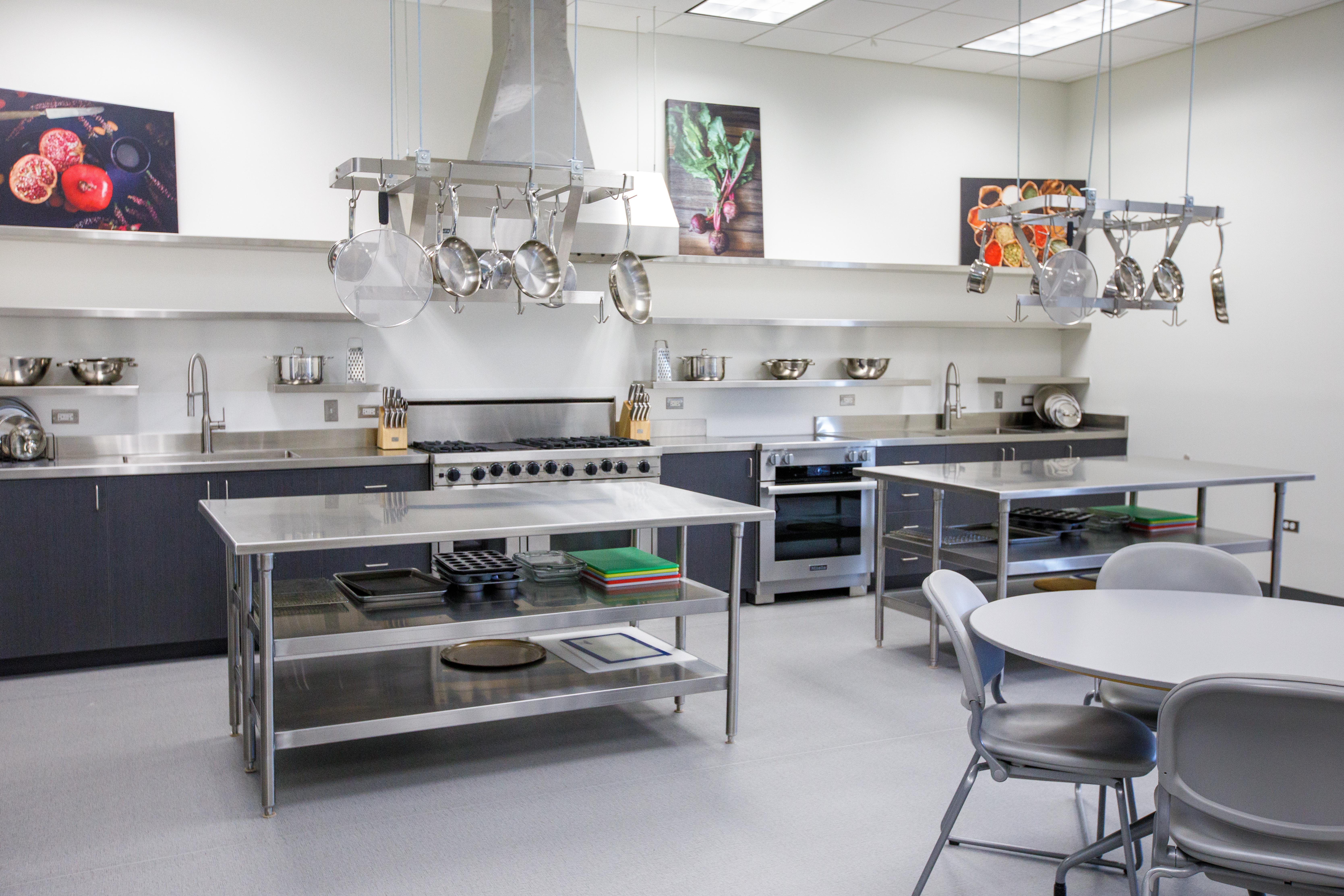 The kitchen area within the Nutrition Lab, along with a round table and chairs