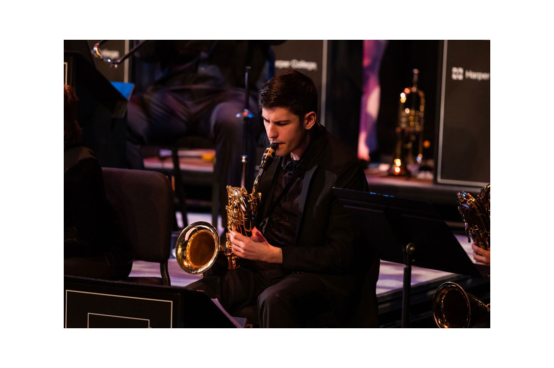 a student plays the saxophone at a concert